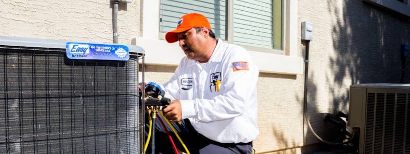 Easy Air technician performing maintenance on an AC Unit