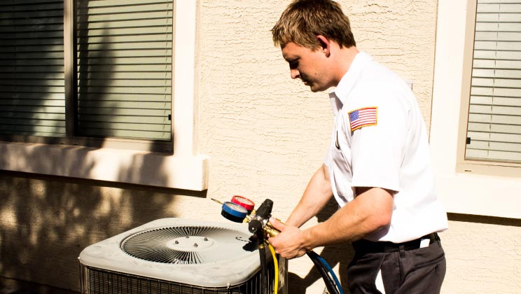 Easy Air technician performing routine maintenance on an AC Unit